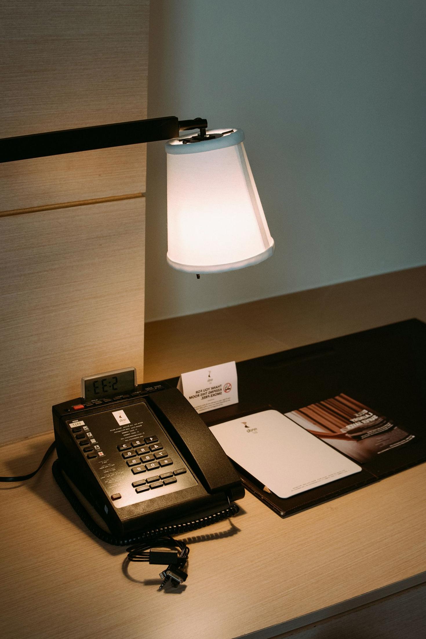 Quiet hotel workspace with desk and lamp