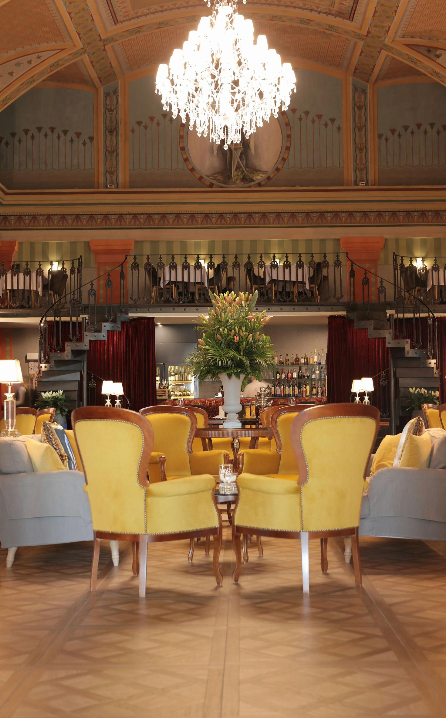 Warmly lit common area with chandeliers